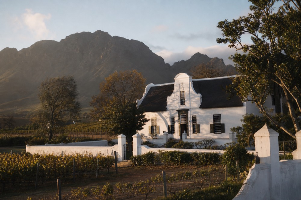Historic Cape Dutch manor house at a Constantia wine estate, no text, no logos, no people