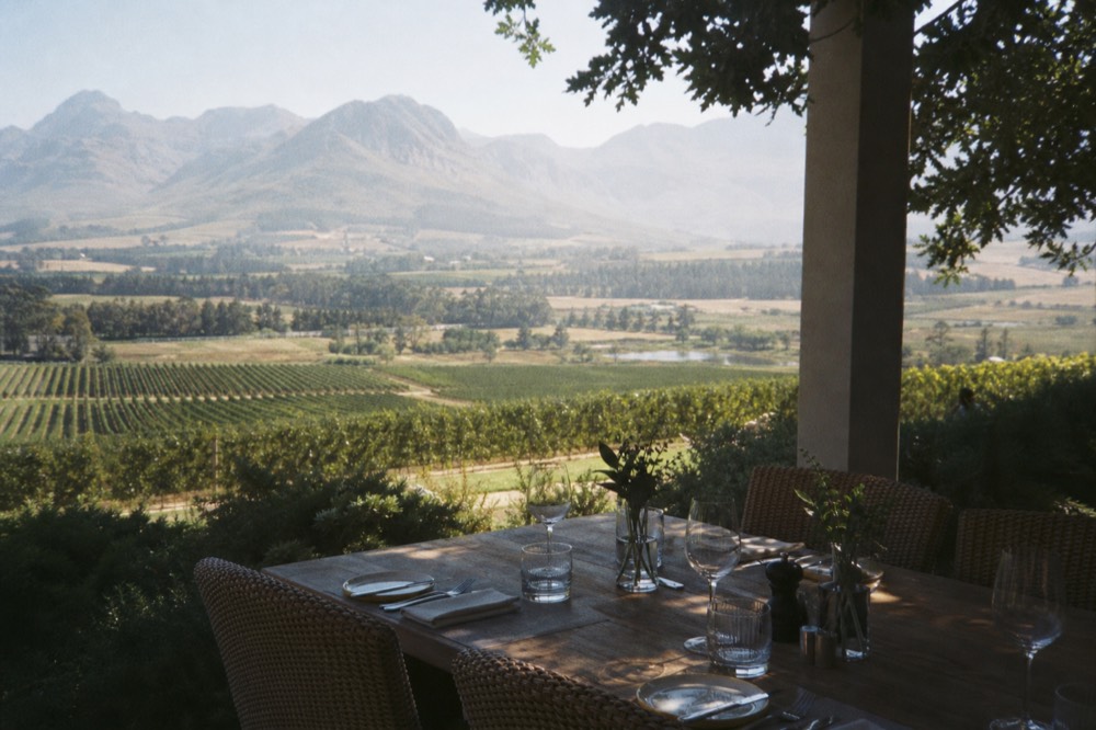 Restaurant terrace overlooking vineyards with set lunch table, no text, no logos, no people